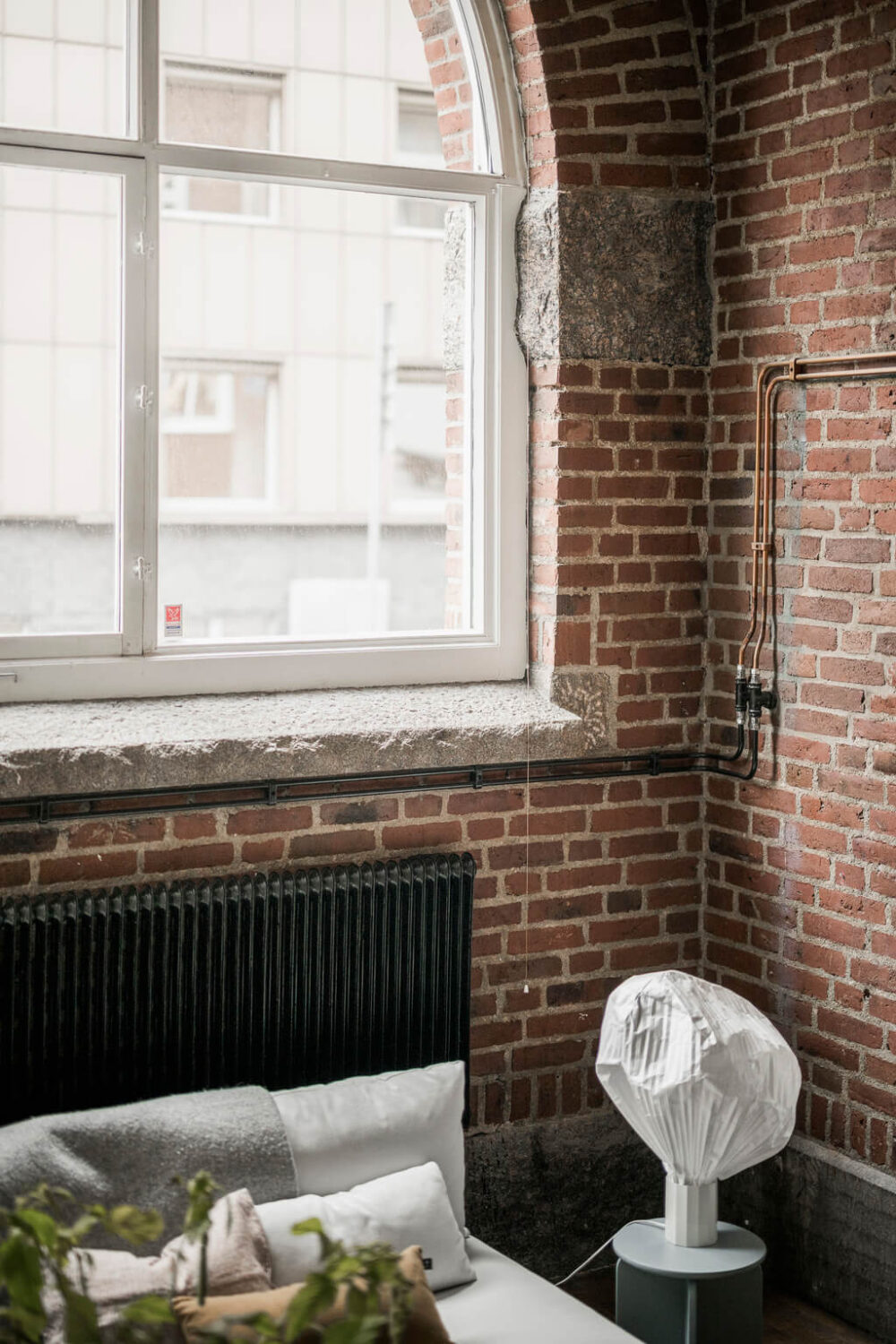 A Scandinavian Loft in an Old Industrial Building 7 exposed brick wall with arched window