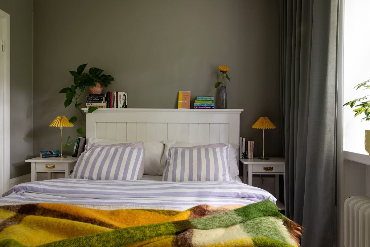 Soft Colors in a Charming Corner Apartment in Stockholm 10 gray bedroom with white bed and colorful throw