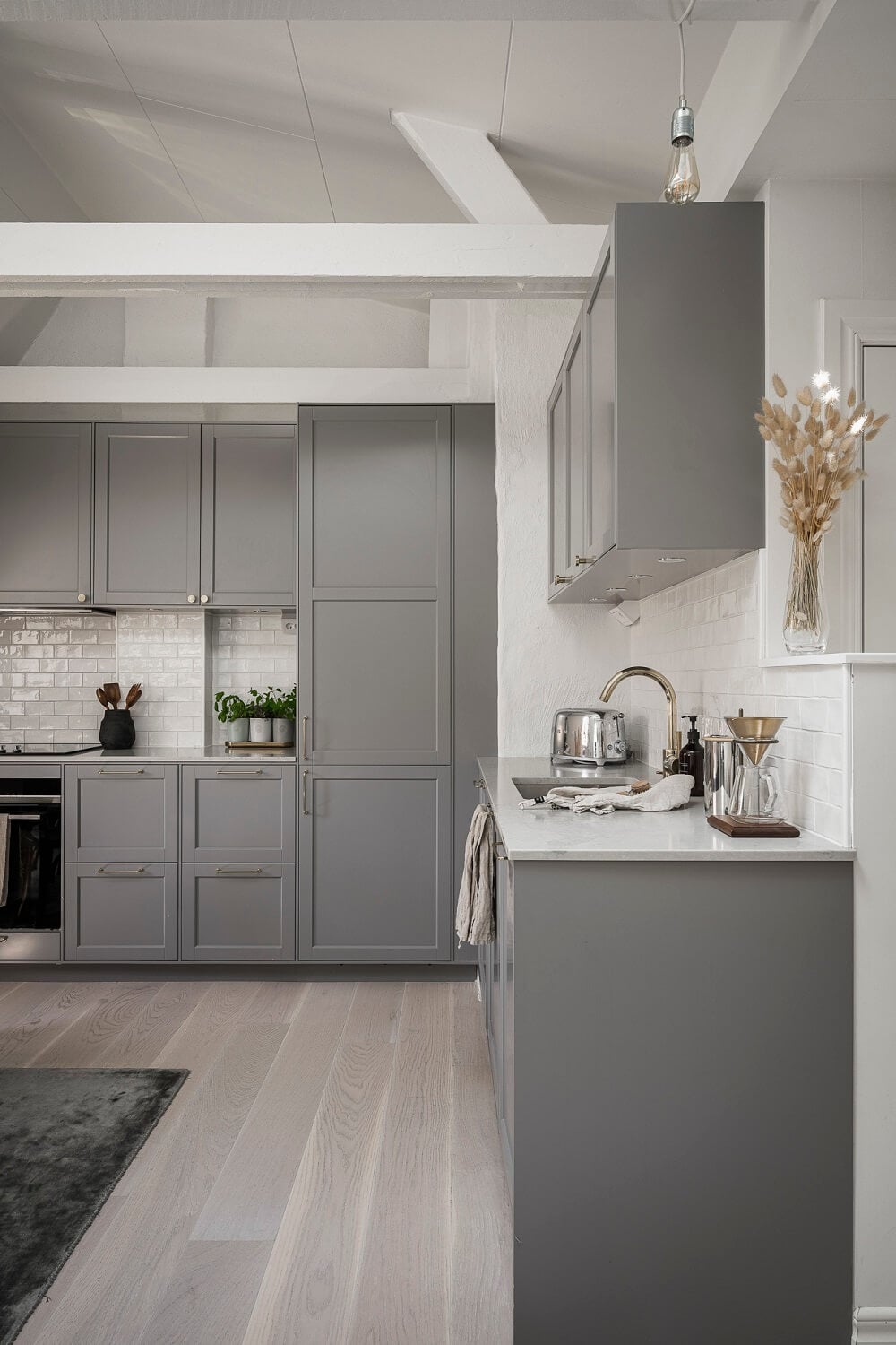 A Swedish Attic Apartment with a Lovely Balcony Overlooking the City 3 gray kitchen attic apartment