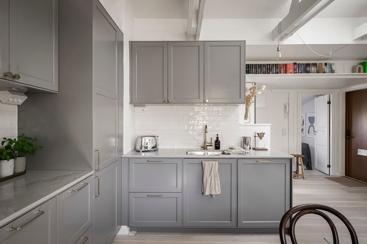 A Swedish Attic Apartment with a Lovely Balcony Overlooking the City 6 gray kitchen open plan living space wooden beams