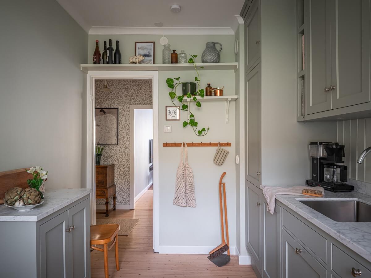 A 1930s Apartment with Gray Rooms and Period Features 12 gray kitchen with shelf above door