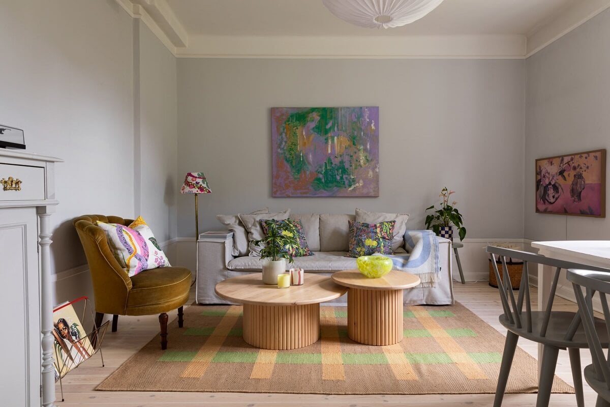 Soft Colors in a Charming Corner Apartment in Stockholm 1 gray living room with round wooden coffee tables