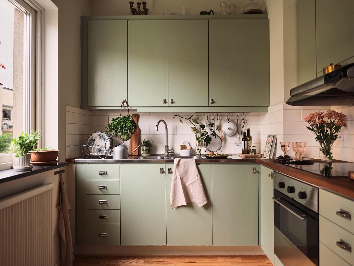 A Small Swedish Apartment with a Social and Semi-Open Floorplan 14 green kitchen