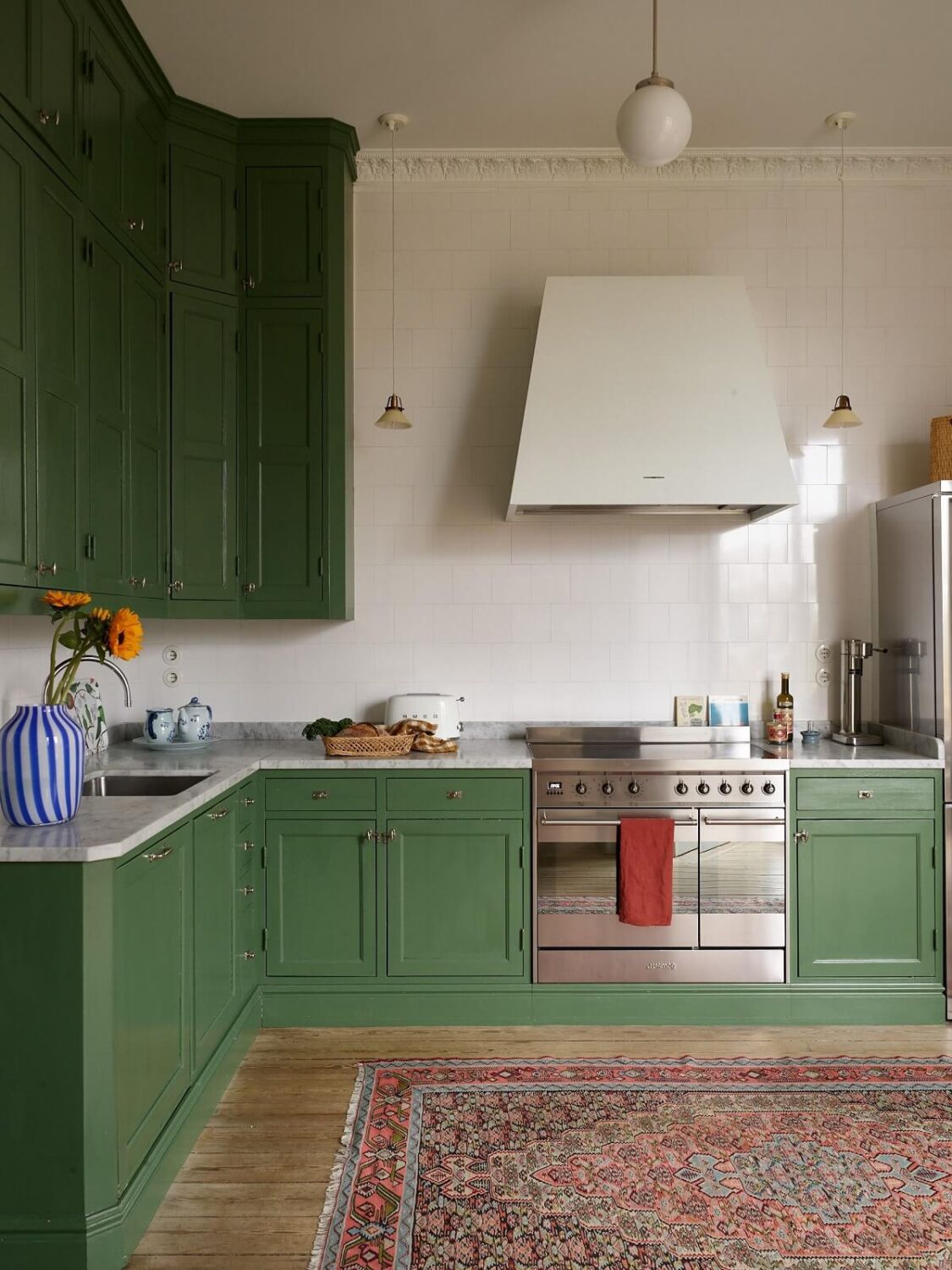 A Colorful Turn-of-the-Century Family Apartment in Stockholm 13 green kitchen cabinets