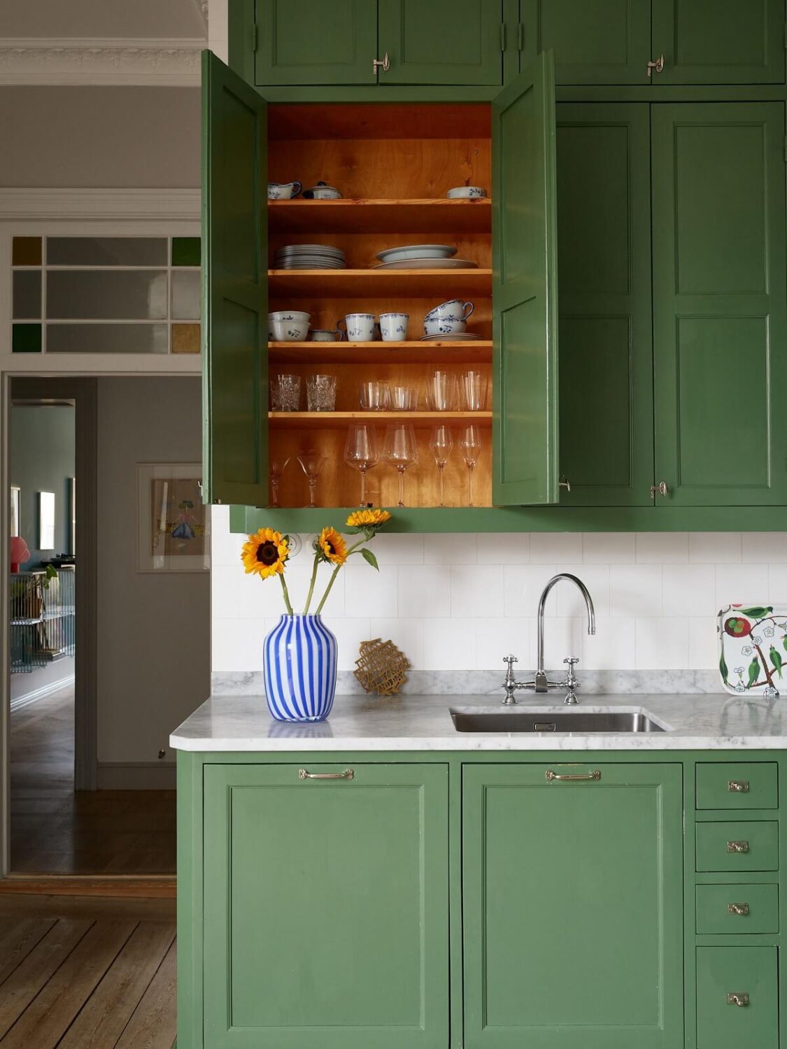 A Colorful Turn-of-the-Century Family Apartment in Stockholm 15 green kitchen cupboards