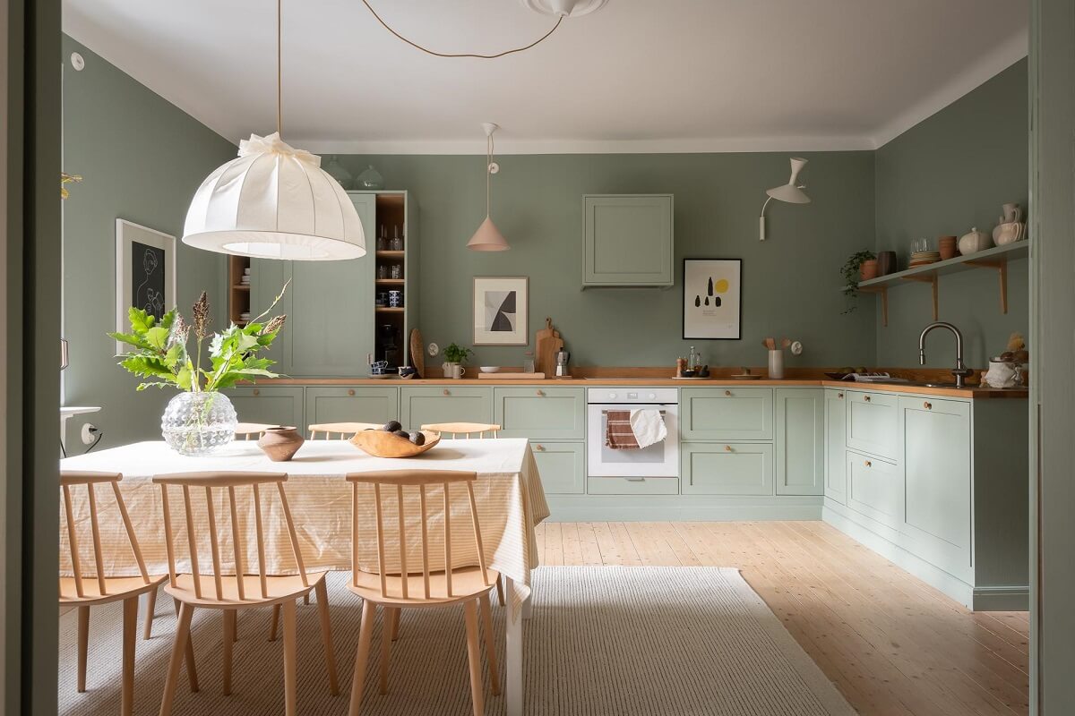 A Swedish Apartment Painted in Calm Beige, Green, and Pink Tones 8 green kitchen sunlight