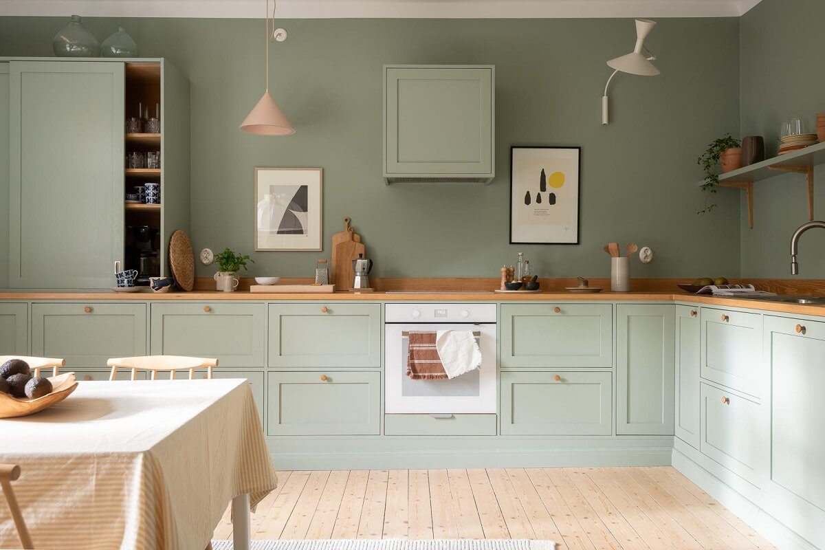 A Swedish Apartment Painted in Calm Beige, Green, and Pink Tones 13 green kitchen wooden worktop