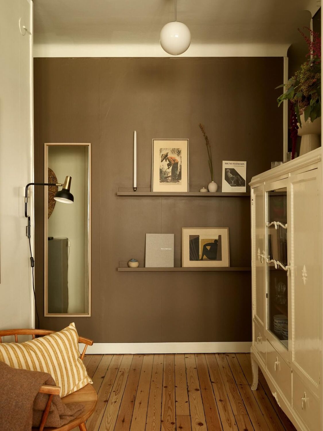 A Lovely Apartment Owned By The Same Family for Almost 100 Years 8 green wall with shelves