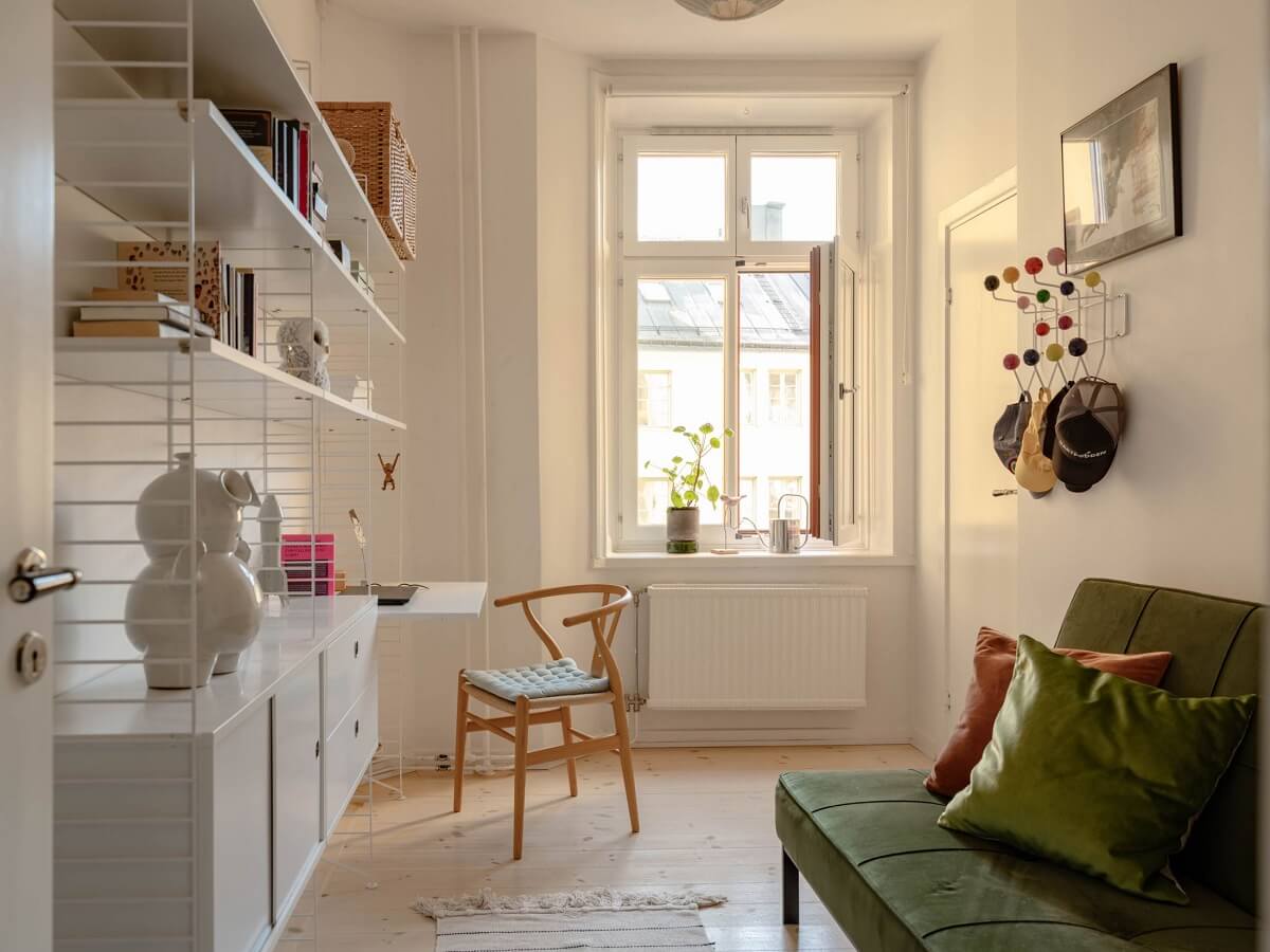 A Spacious Stockholm Apartment with Light Gray Walls 20 guest bedroom string shelves with desk and green sleeper sofa