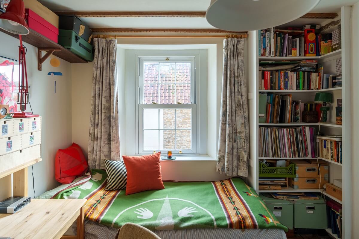 Colorful Furniture in a Historic English Cottage 12 guest room with bookshelves