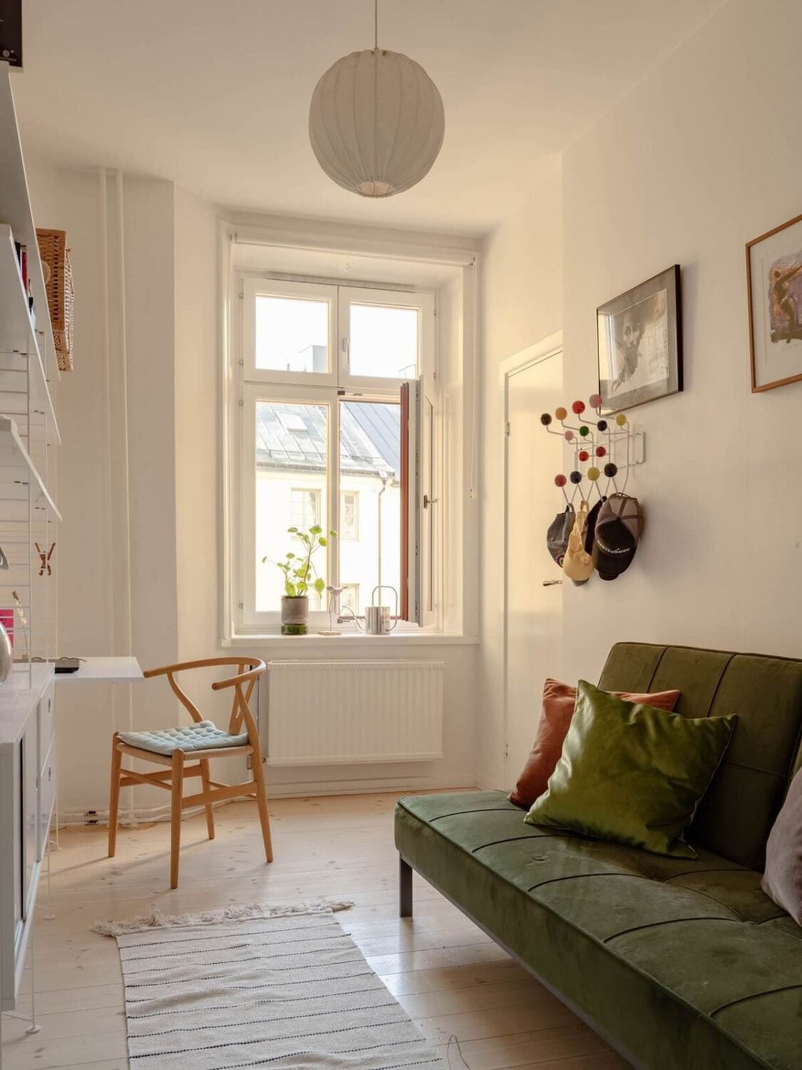 A Spacious Stockholm Apartment with Light Gray Walls 21 guest room with desk and green sleeper sofa A Spacious Stockholm Apartment with Light Gray Walls