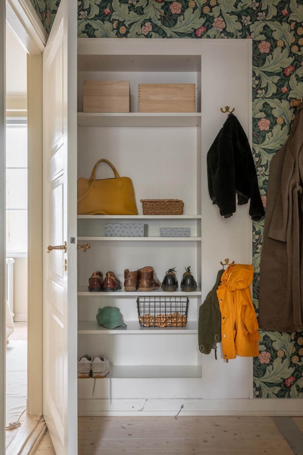 A Swedish Apartment Painted in Calm Beige, Green, and Pink Tones 29 hall built in cabinet
