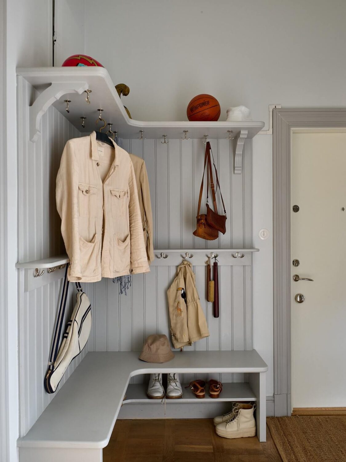 A Colorful Turn-of-the-Century Family Apartment in Stockholm 38 hall entry corner coat storage and seating bench with shoe storage