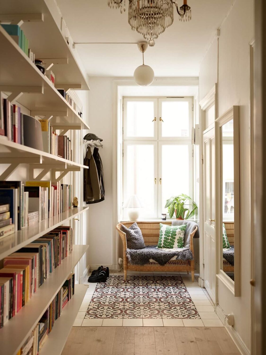A Light Corner Apartment with 1890s Period Features 24 hall with bookshelves and sofa