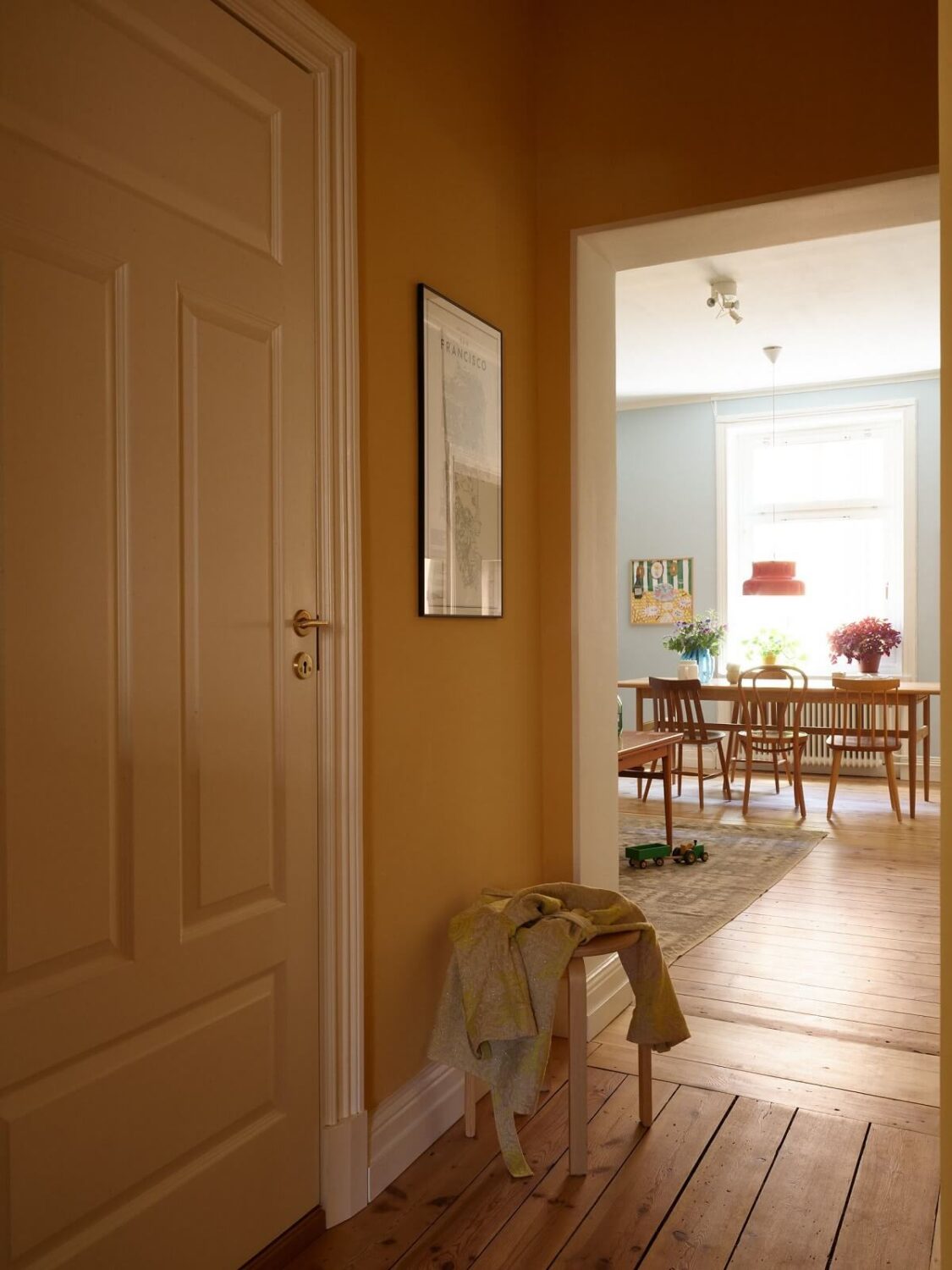 A Light Turn-of-the-Century Apartment with a Cheerful Color Palette 10 hall wooden floorboards yellow wall