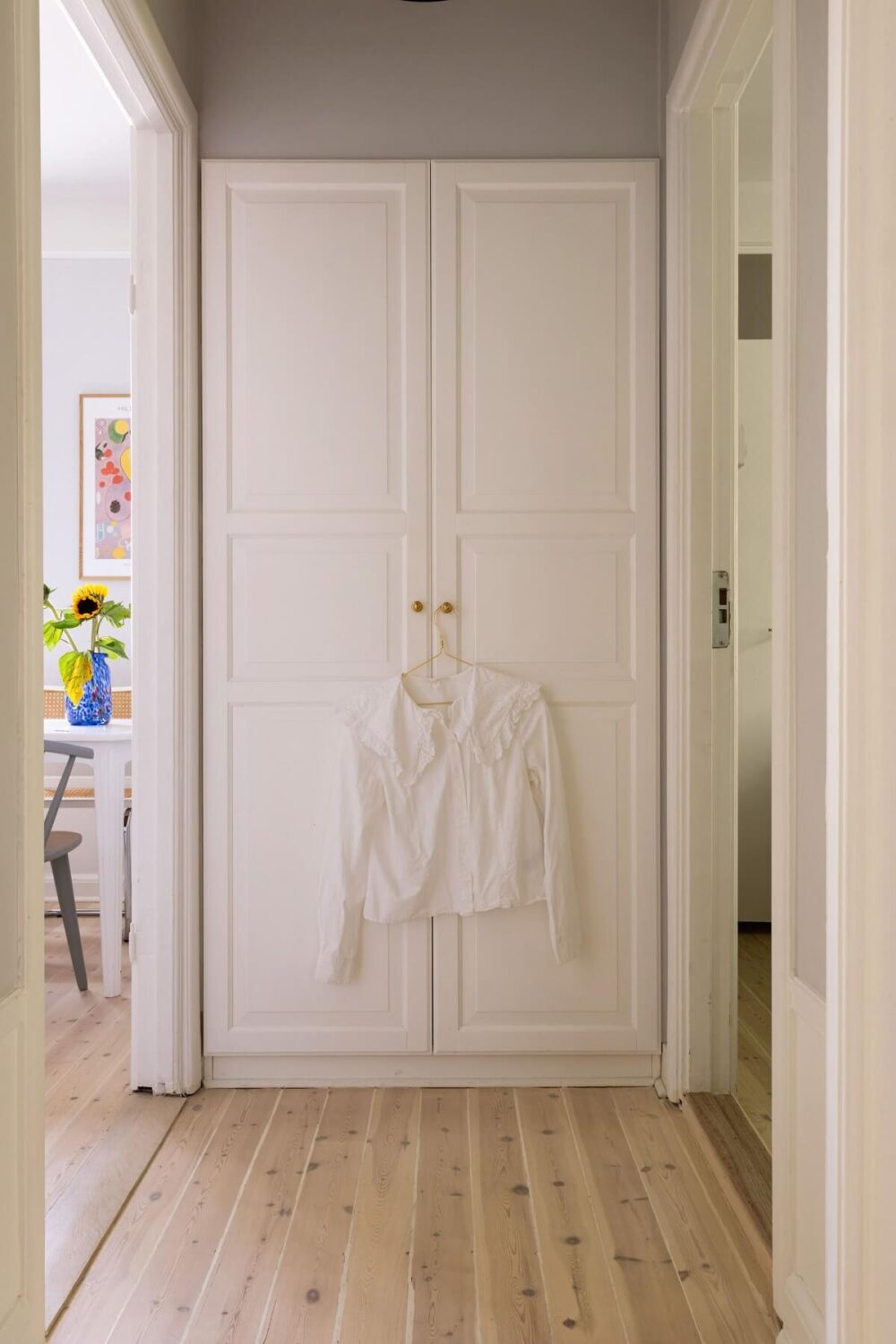 Soft Colors in a Charming Corner Apartment in Stockholm 20 hallway built in cabinet