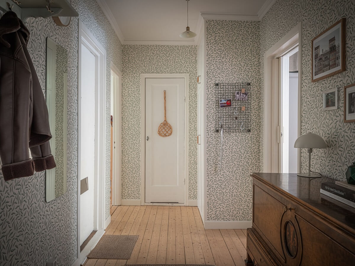 A 1930s Apartment with Gray Rooms and Period Features 18 hallway william morris wallpaper wooden floor