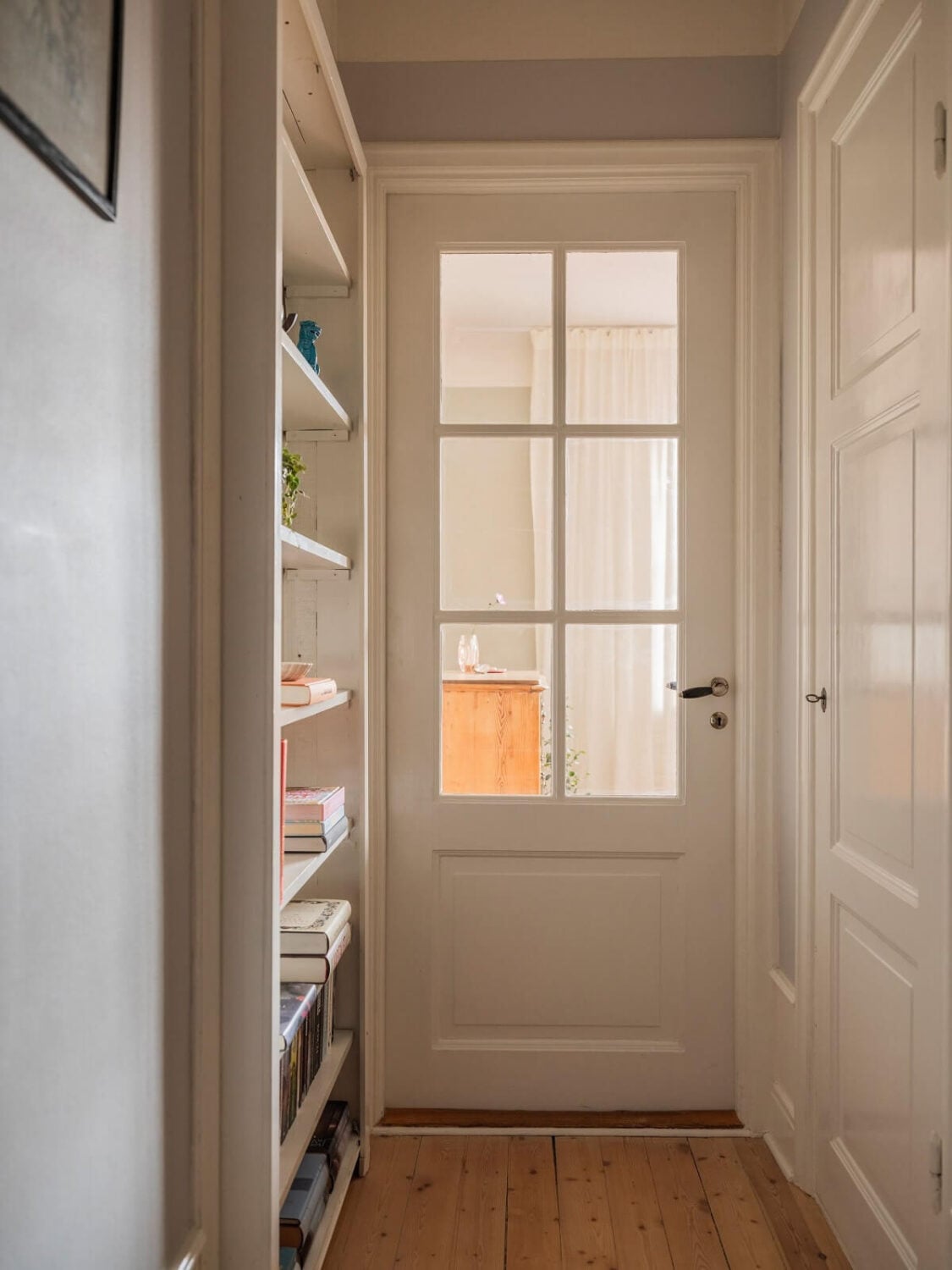 A Living Room with Light Purple Walls in a Swedish Apartment 15 hallway with built in shelves