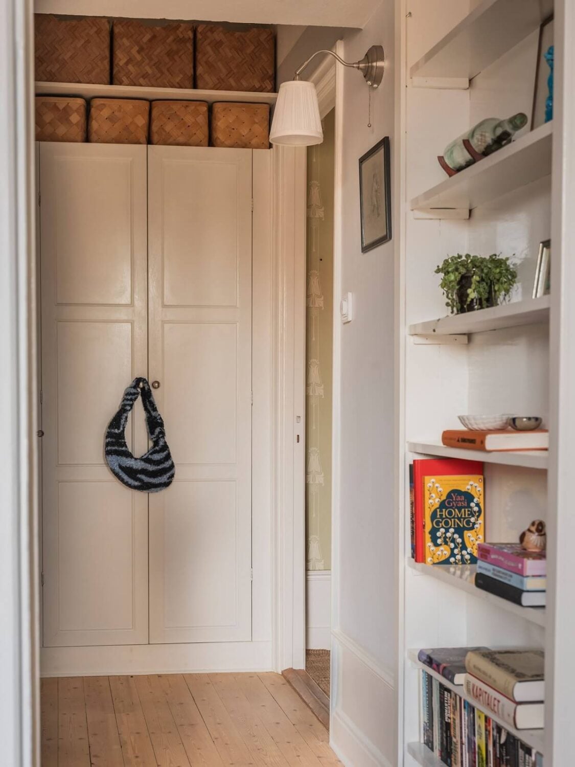 A Living Room with Light Purple Walls in a Swedish Apartment 16 hallway with built in storage