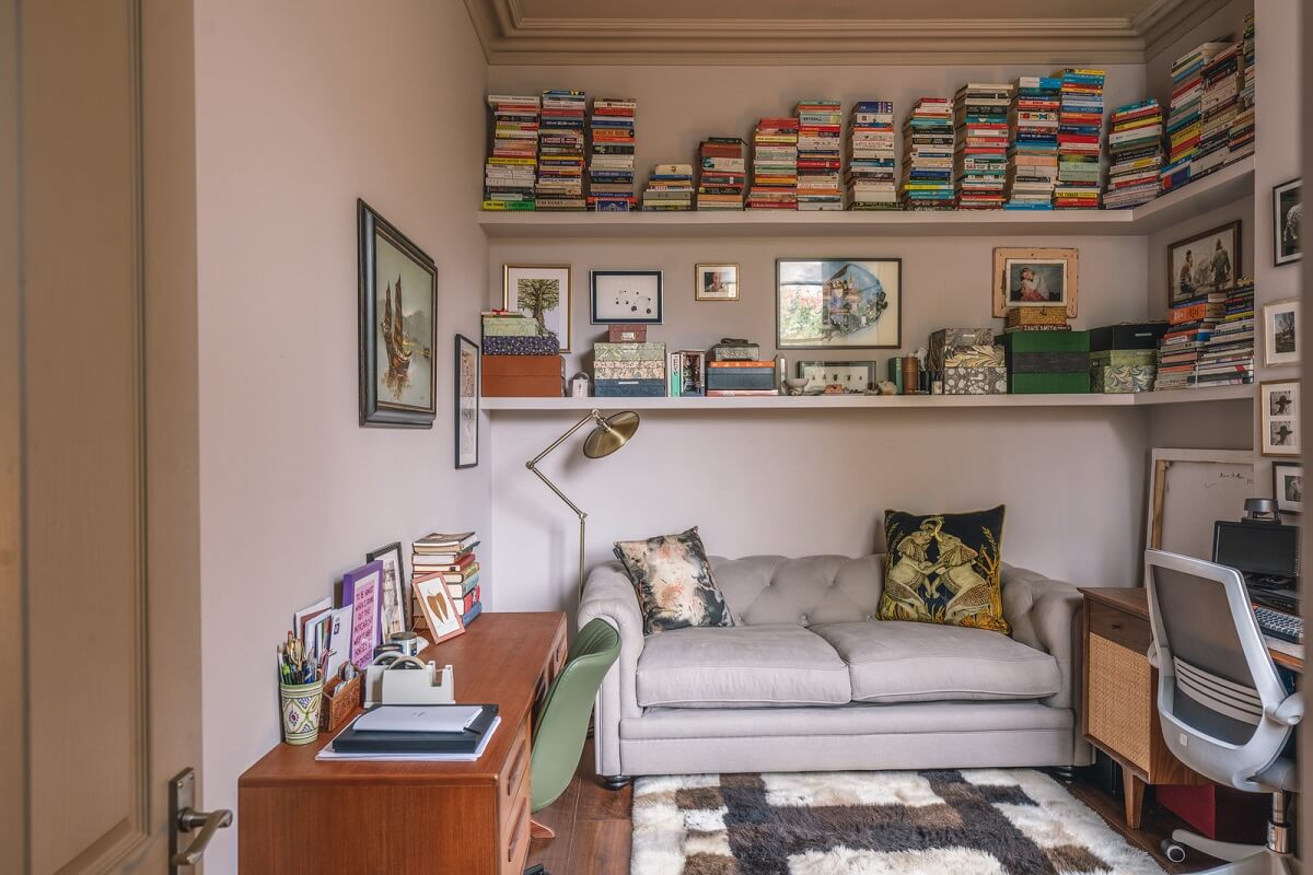 A Grand Ground Floor Apartment with Dark Blue Walls and a Garden 15 home office with sofa and bookshelves nordroom