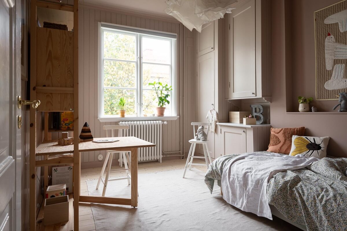 A Swedish Apartment Painted in Calm Beige, Green, and Pink Tones 21 kids bedroom pink walls ikea ivar desk cabinet