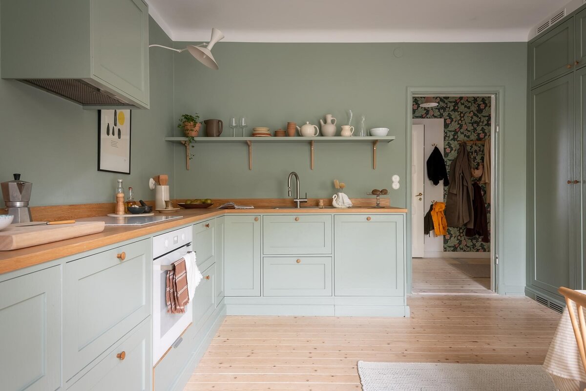 A Swedish Apartment Painted in Calm Beige, Green, and Pink Tones 14 kitchen green walls cabinets