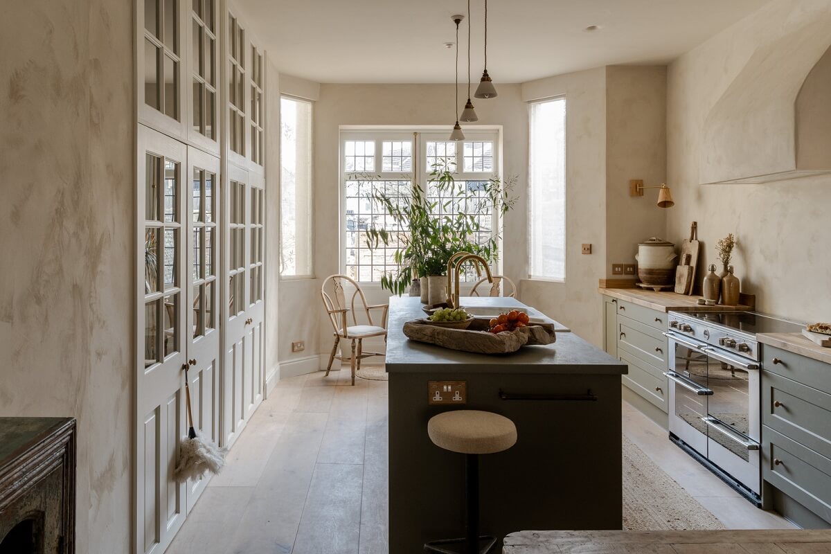 Best of 2024: Kitchens 9 kitchen with bay window island and floor to ceiling built in cabinets with glass doors