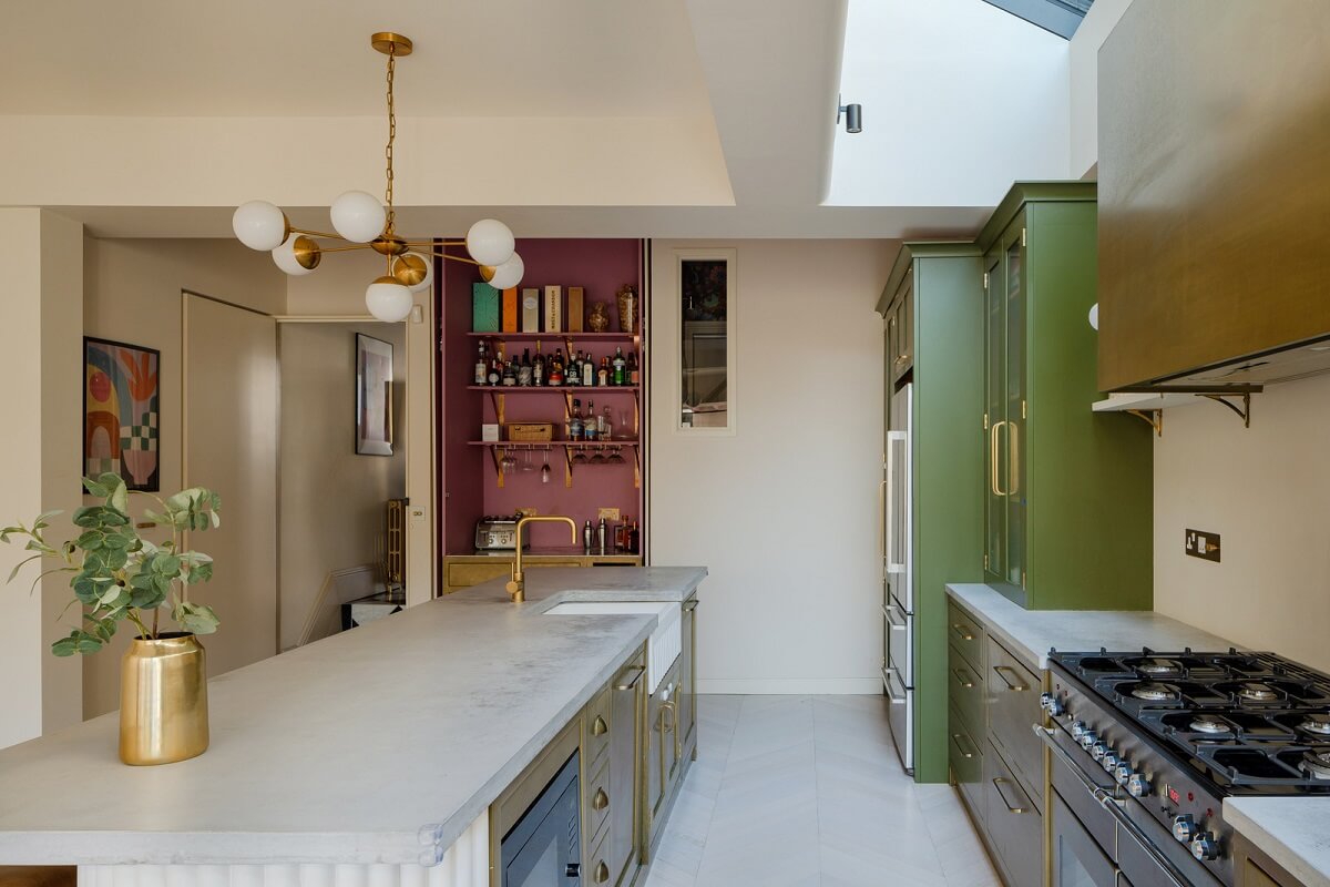 A Colorful Edwardian Family Home in London 7 kitchen with brass green and pink cabinets