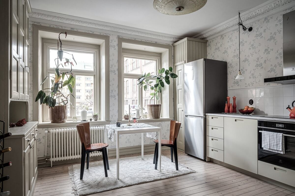 A Stately Apartment with Period Details and Wallpapers 8 kitchen with light floral wallpaper and two large windows