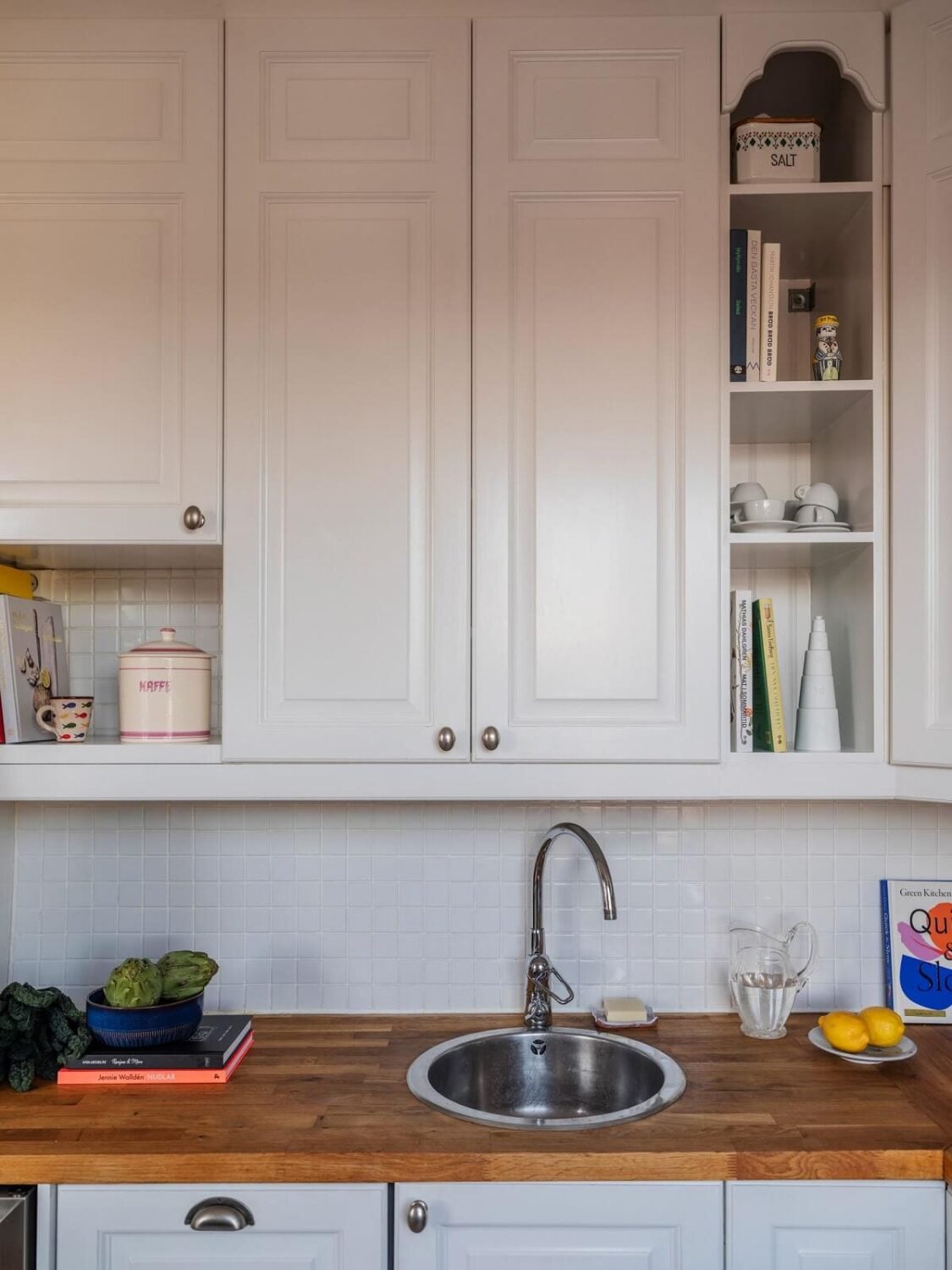 A Living Room with Light Purple Walls in a Swedish Apartment 8 kitchen with open cupboards