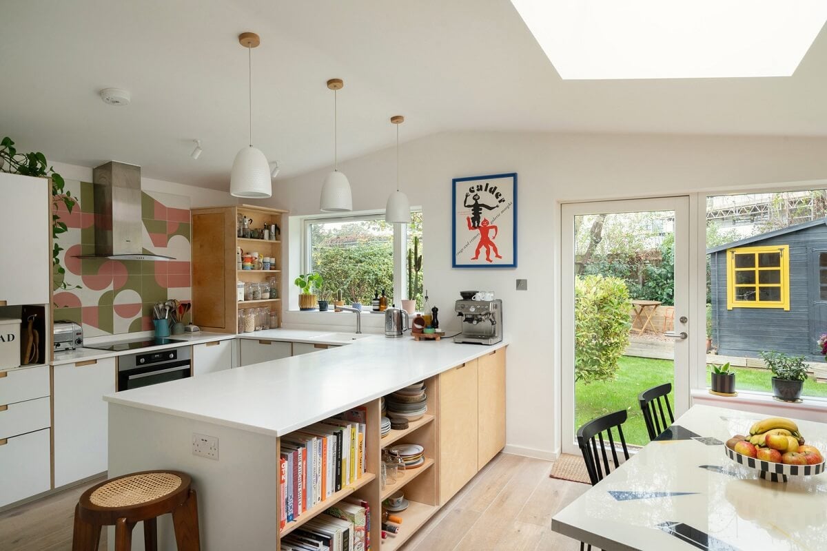 Colorful Rooms and Period Features in a London Terrace House 7 kitchen with white cabinets and skylights
