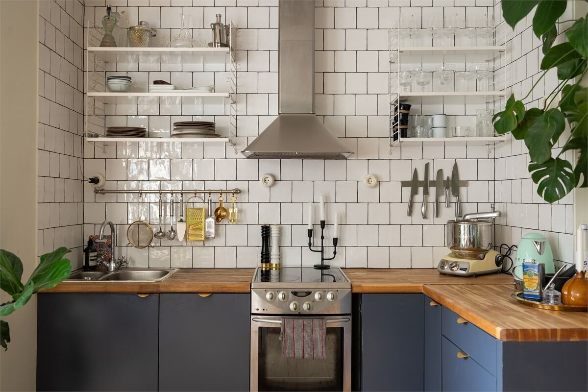 Green Tones in a Turn-of-the-Century Stockholm Apartment 5 kitchen with white tiles and shelves