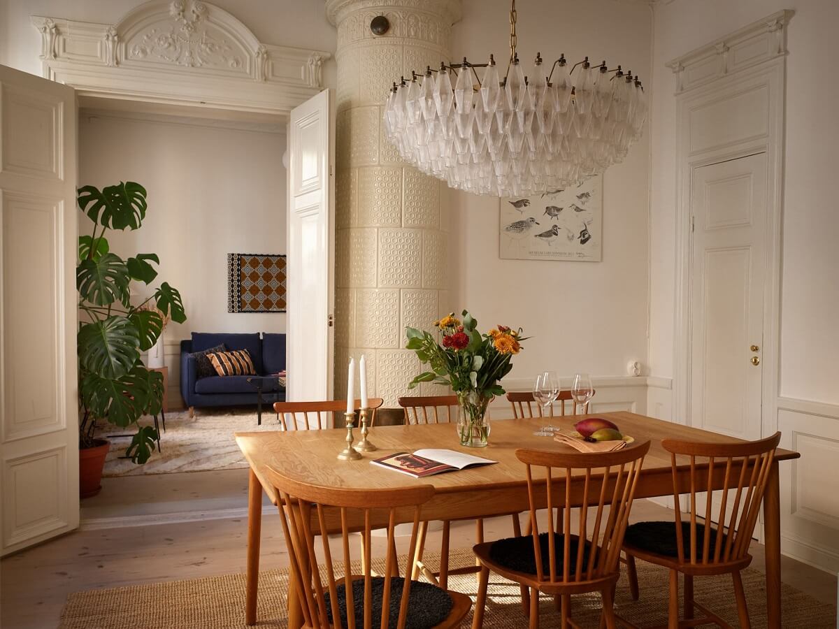 A Light Corner Apartment with 1890s Period Features 7 large chandelier dining room