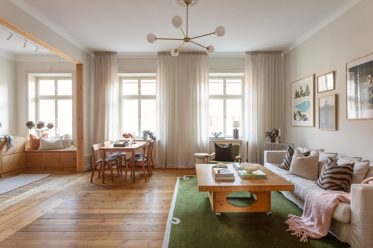 A Turn-of-the-Century Apartment with Warm Open-Plan Spaces 2 large windows in open plan living room and kitchen