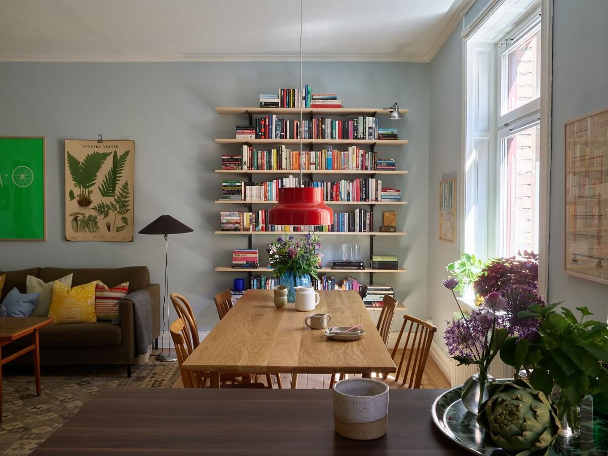 A Light Turn-of-the-Century Apartment with a Cheerful Color Palette 4 light blue living room bookshelves