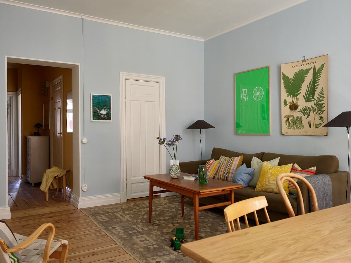 A Light Turn-of-the-Century Apartment with a Cheerful Color Palette 9 light blue sitting room