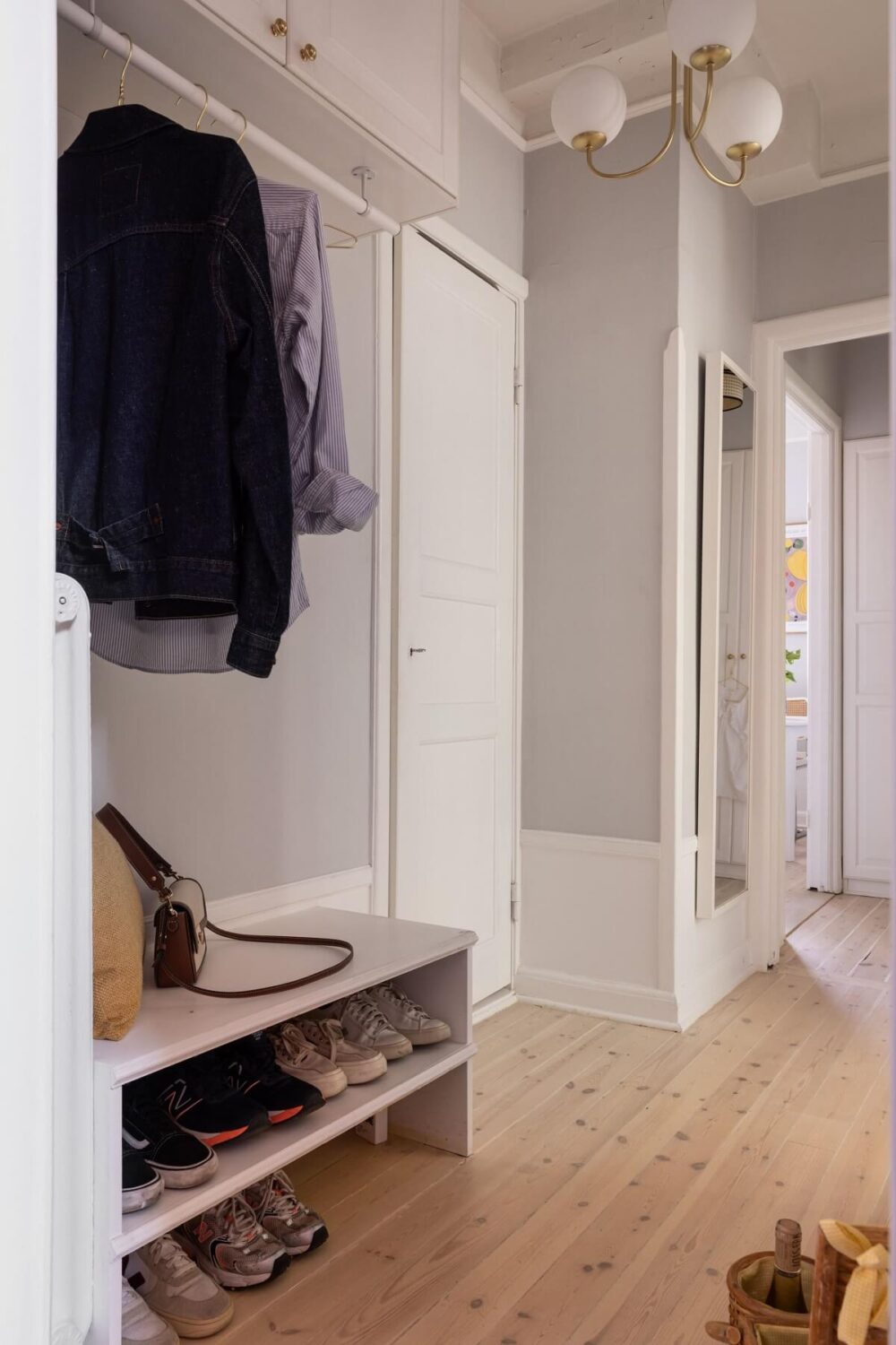 Soft Colors in a Charming Corner Apartment in Stockholm 22 light gray hall with storage space