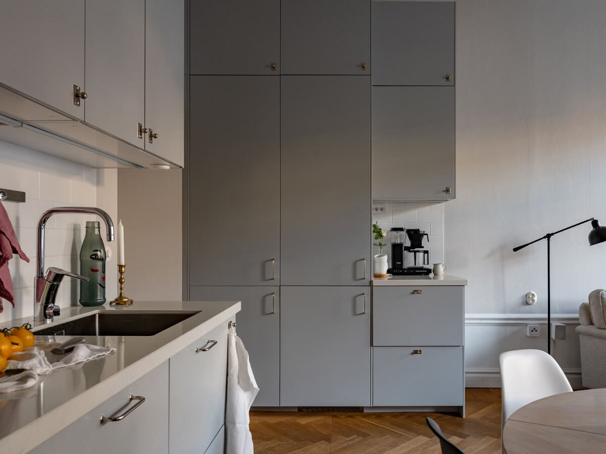 An 1890s Stockholm Apartment with a Blue Bedroom 6 light gray kitchen with floor to ceiling cabinets nordroom