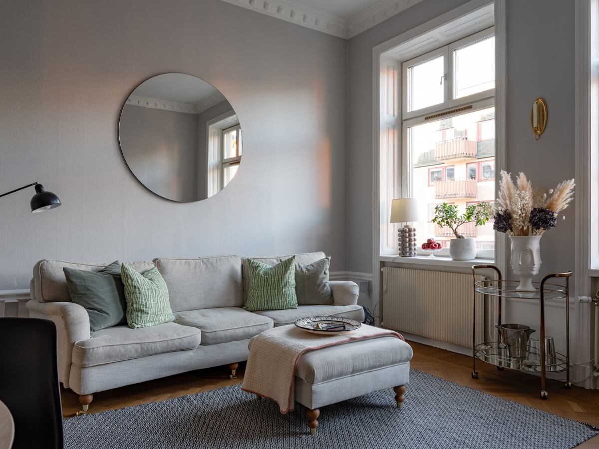 An 1890s Stockholm Apartment with a Blue Bedroom 2 light gray living room round mirror