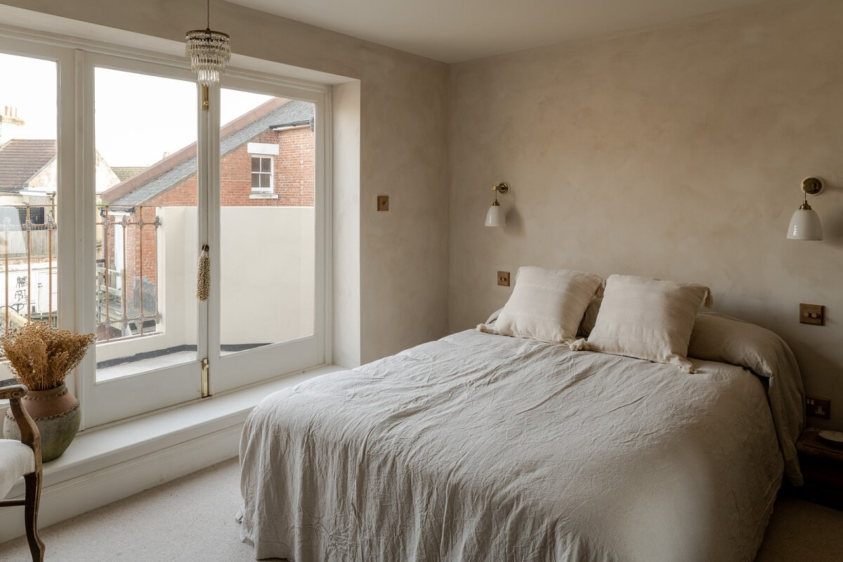 Limewash Walls and Restored Period Features in a Calm English Home 17 light limewash bedroom with balcony