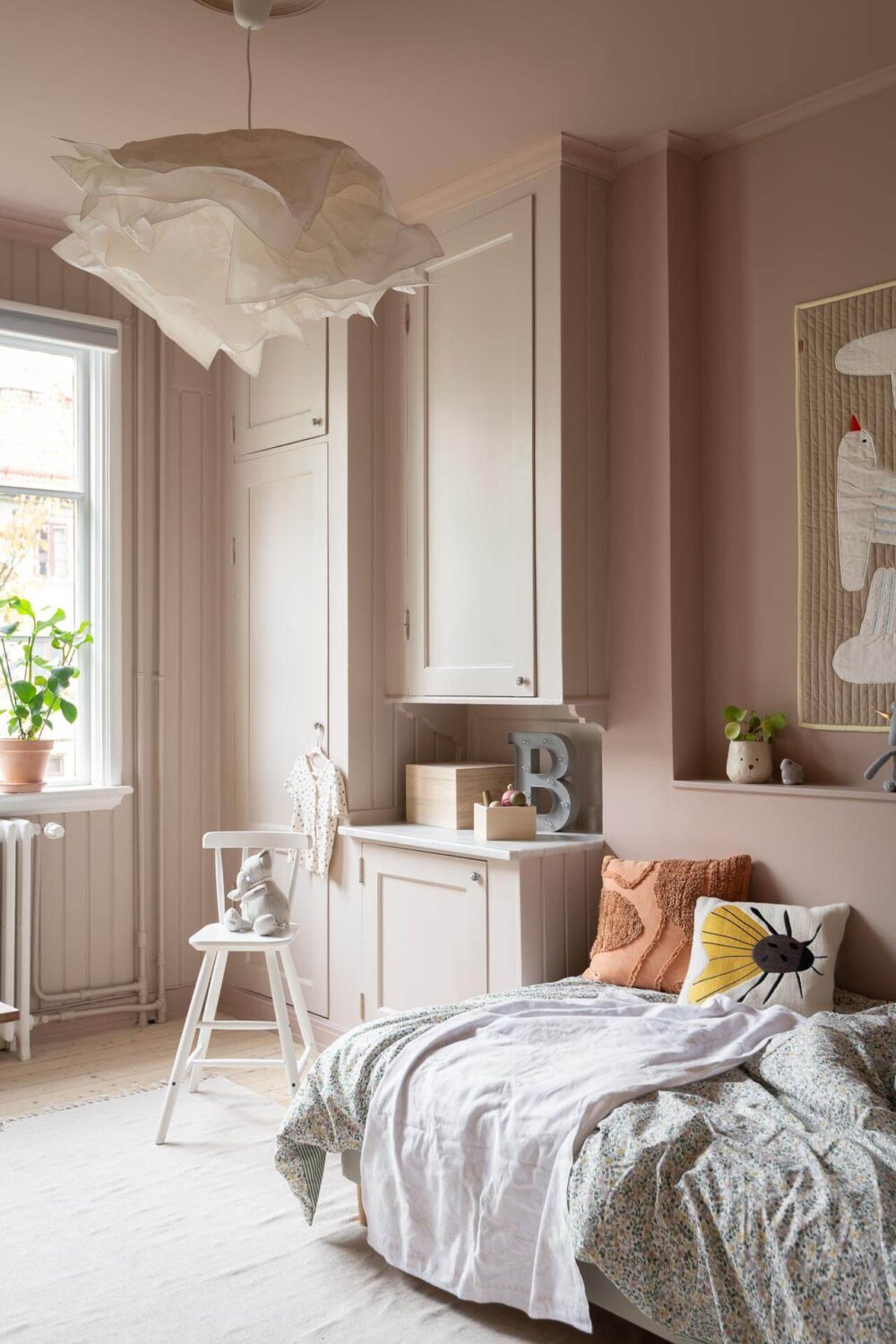 A Swedish Apartment Painted in Calm Beige, Green, and Pink Tones 23 light pink childrens bedroom