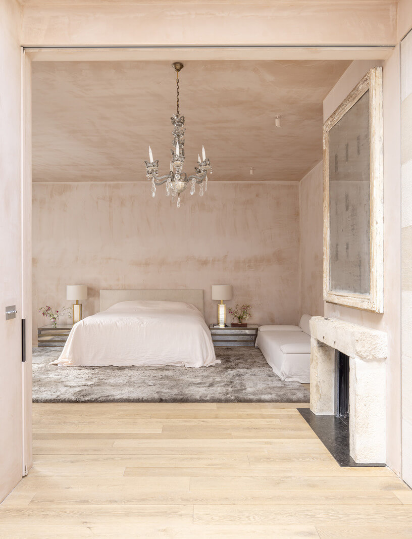 A Grand Industrial Warehouse Conversion in London 27 limewash master suite with fireplace A Grand Industrial Warehouse Conversion in London