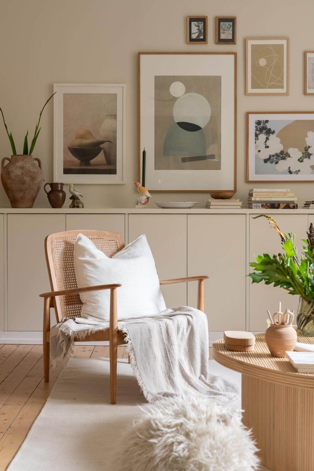 A Swedish Apartment Painted in Calm Beige, Green, and Pink Tones 4 living room accent chair art