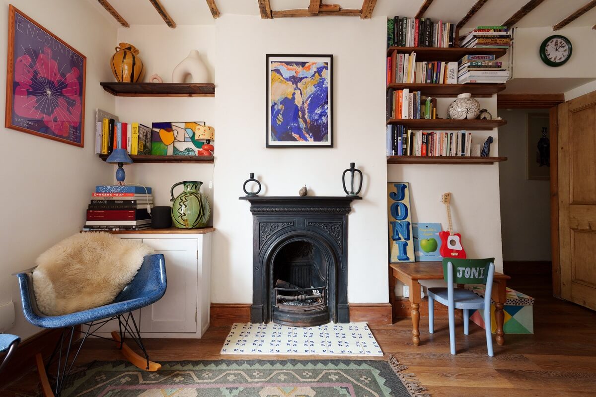Colorful Furniture in a Historic English Cottage 3 living room black fireplace wooden beams bookshelves