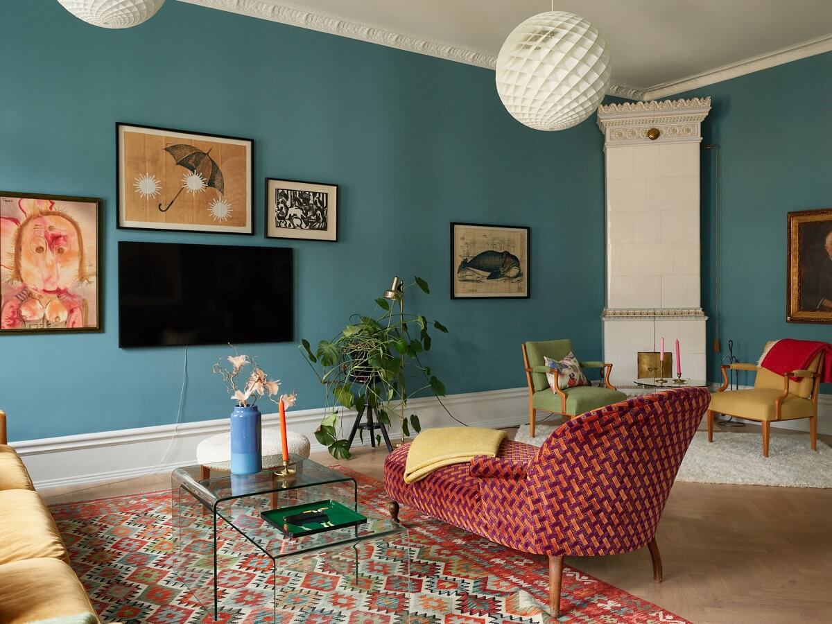 A Colorful Turn-of-the-Century Family Apartment in Stockholm 4 living room blue walls colorful furniture white tiles fireplace
