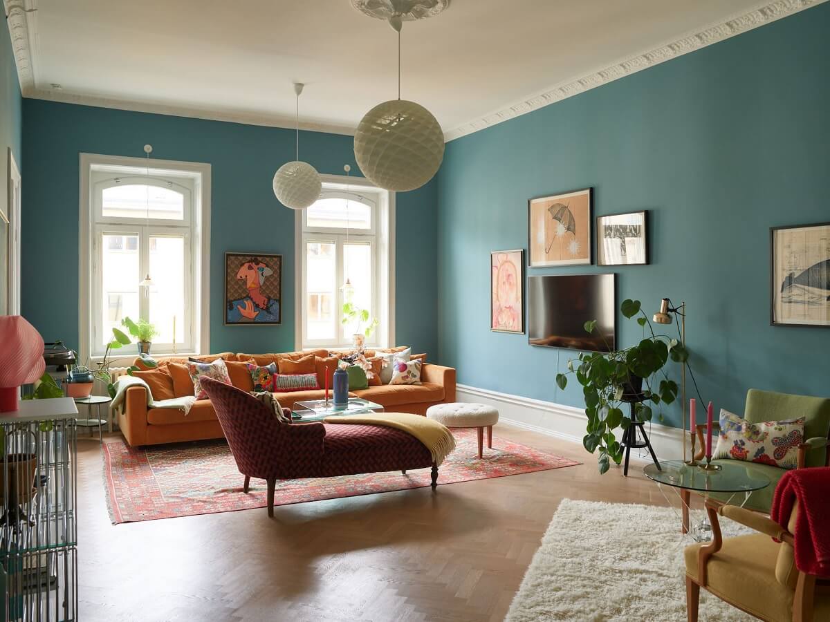 living room blue walls parquet floor colorful furniture