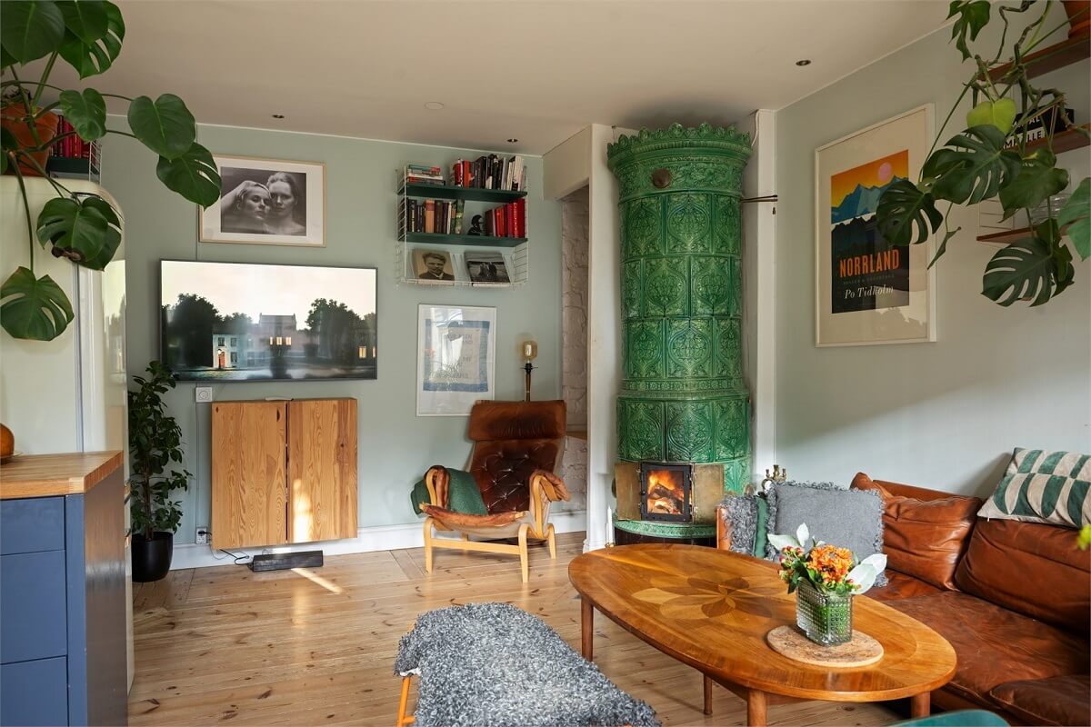 Green Tones in a Turn-of-the-Century Stockholm Apartment 8 living room green fireplace