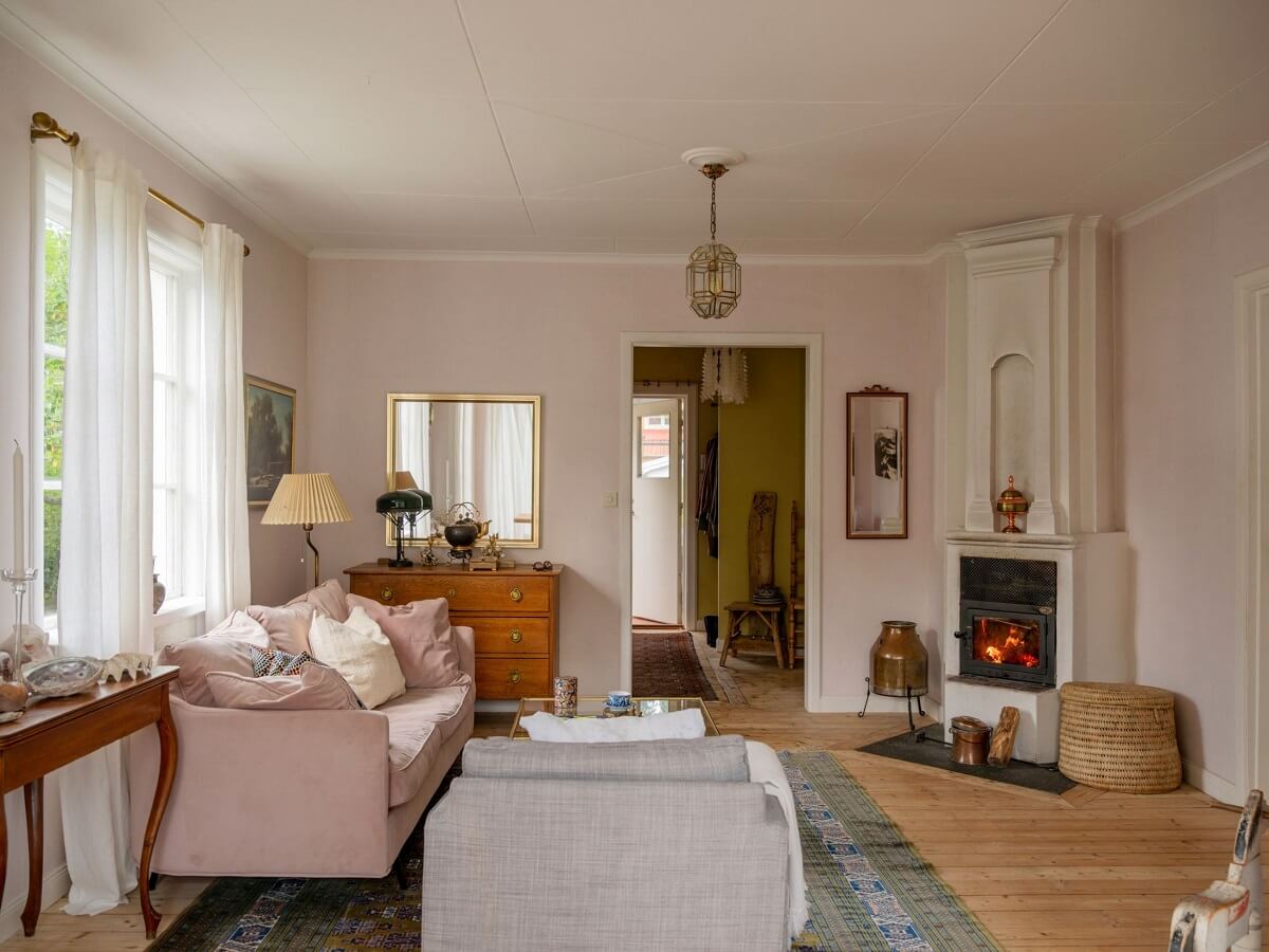 A Romantic 1920s Villa with Views of the Lake 5 living room pink walls fireplace A Romantic 1920s Villa with Views of the Lake