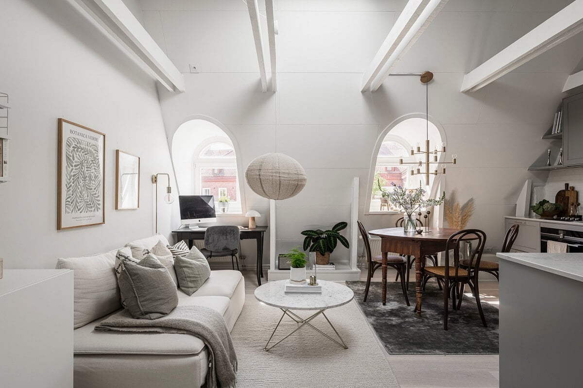 A Swedish Attic Apartment with a Lovely Balcony Overlooking the City 7 living room pitched ceiling exposed beams dormer window