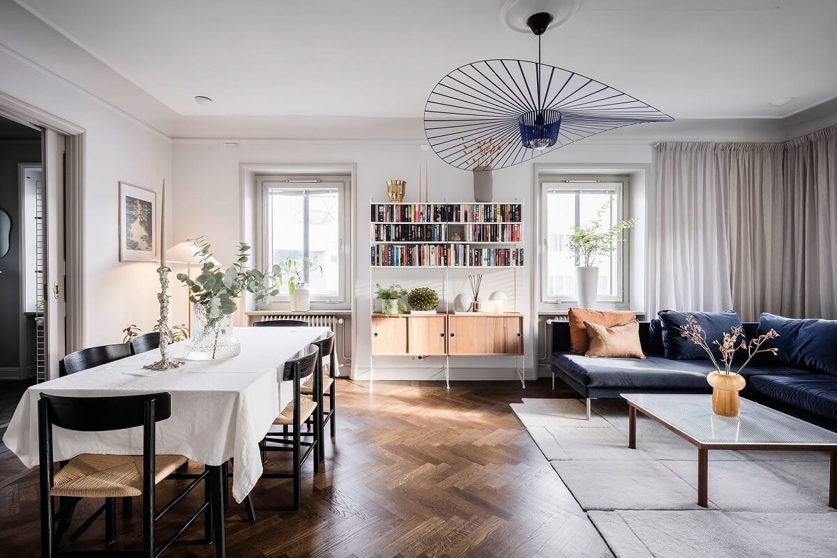 A Burgundy Kitchen in a Stylish Scandinavian Apartment 6 living room with dining table and parquet floor